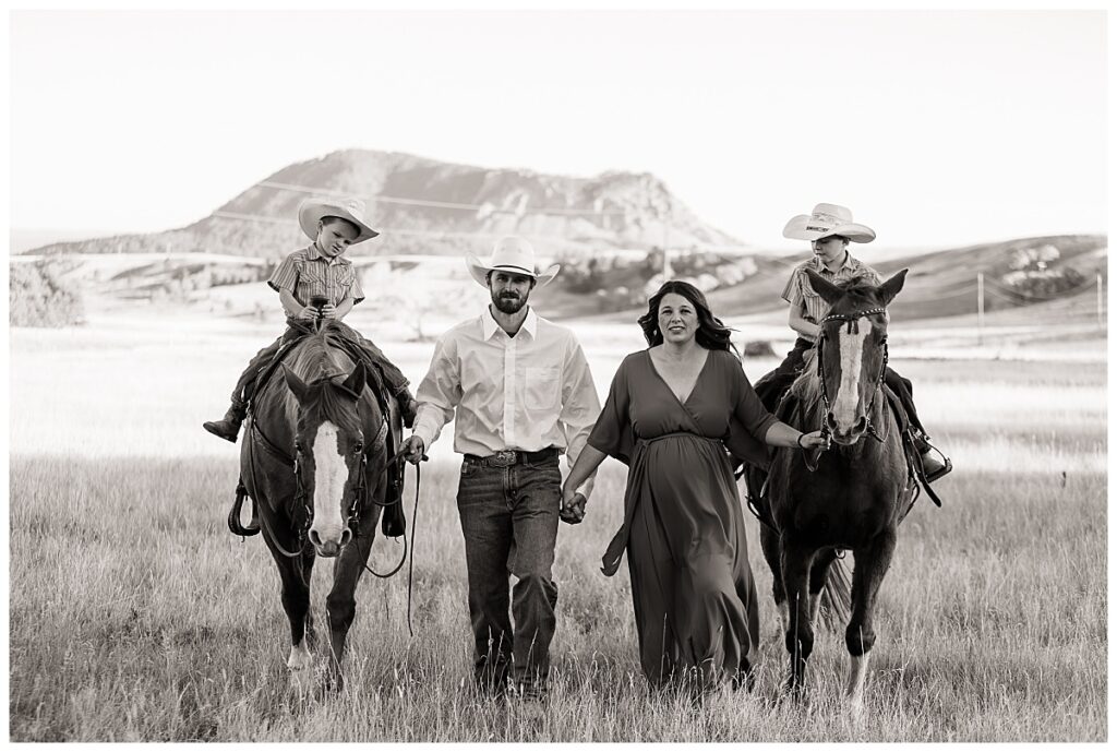 Family walking with children on horses